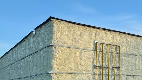 Outside of a building covered with spray foam insulation.